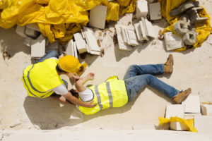 Personal Injury Lawyer Memphis, TN with a construction worker assisting a coworker that's fallen