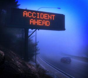 car accident lawyer Memphis TN with a traffic sign in fog warning of an accident