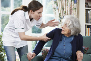Nursing home staff yelling at an elderly woman