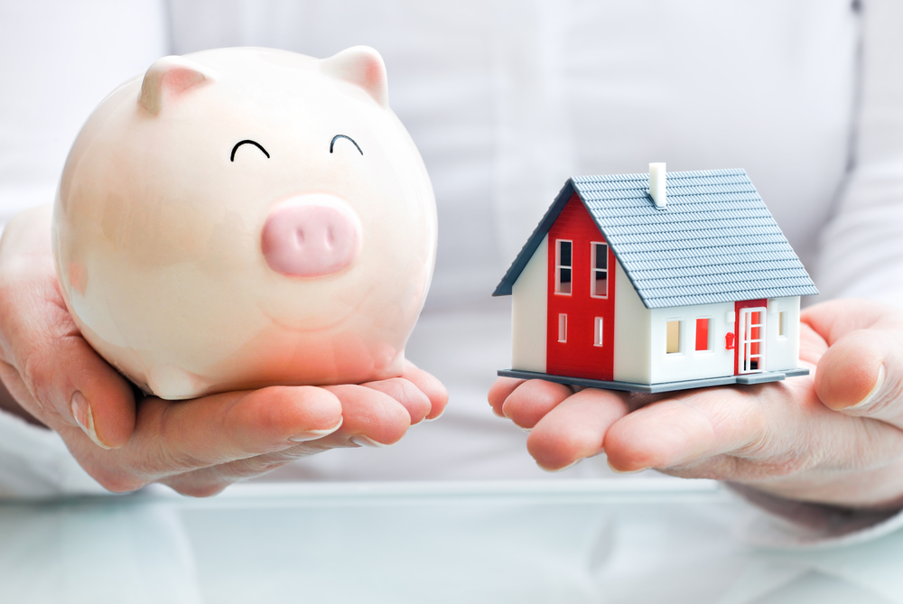 Basics Of Probate - Hands holding a piggy bank and a house model